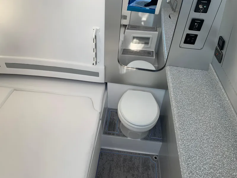 Slide: The Image of 2023 Mystic Powerboats M3800 interior bathroom with modern fixtures and sleek design. - 9