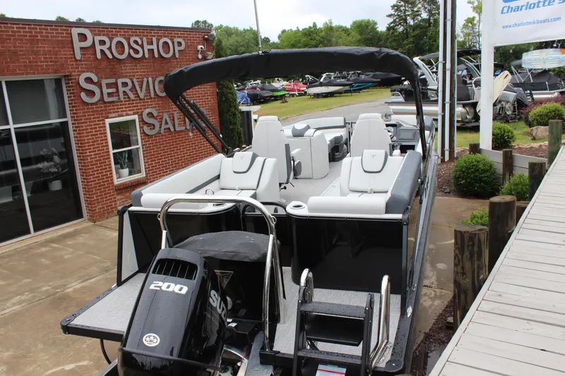 Slide: The Image of 2025 Tahoe Pontoon Cascade Quad Lounger at dealership, featuring sleek design and powerful 200 HP engine. - 4