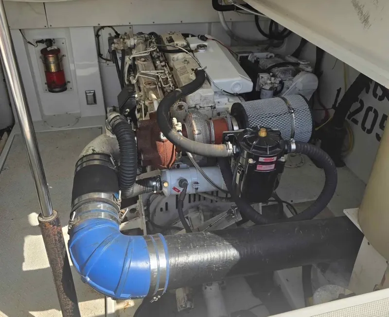 Slide: The Image of Engine compartment of a 2000 Rampage 38 Express boat, showcasing mechanical components and systems. - 11