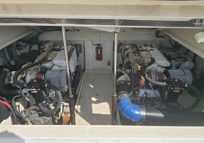 Slide: The Image of Engine compartment of a 2000 Rampage 38 Express boat, showcasing dual engines. - 12