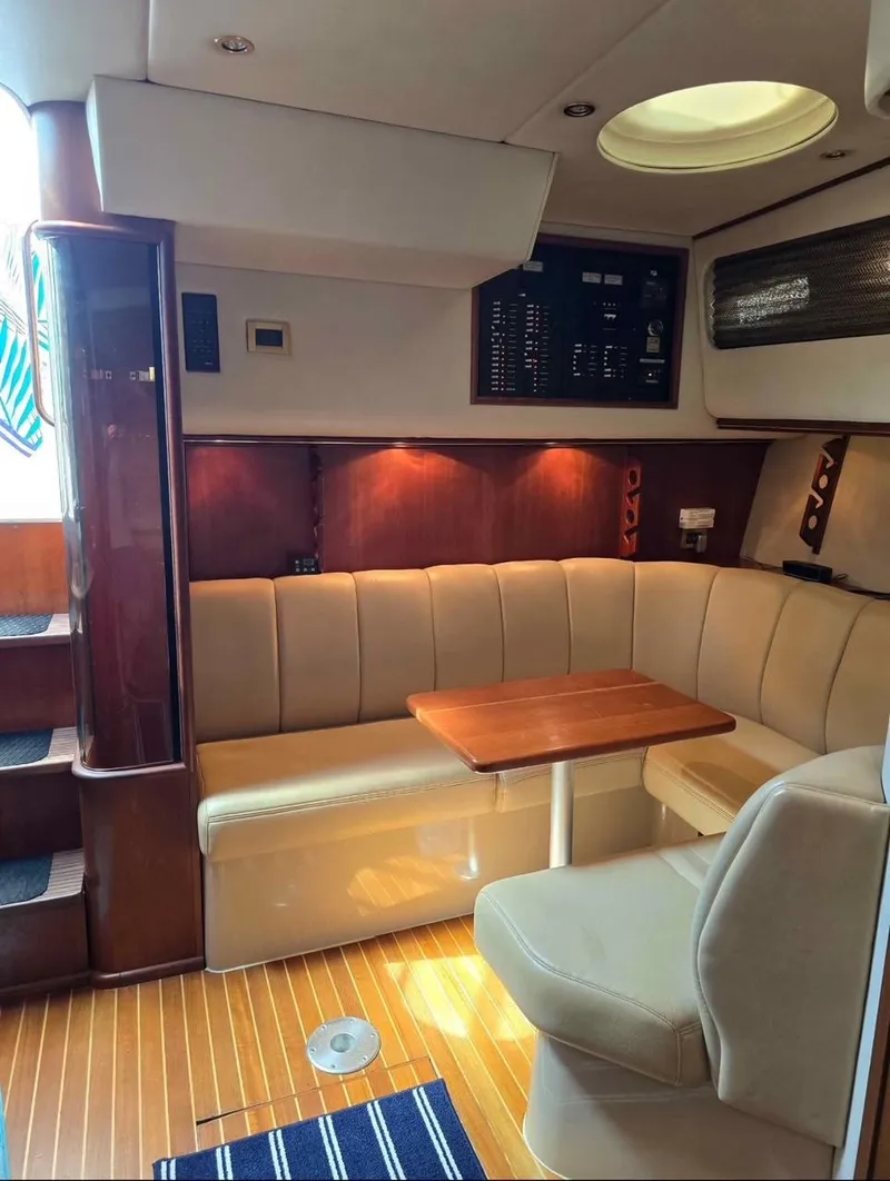 Slide: The Image of 2000 Rampage 38 Express cabin interior with seating, table, and control panel. - 6