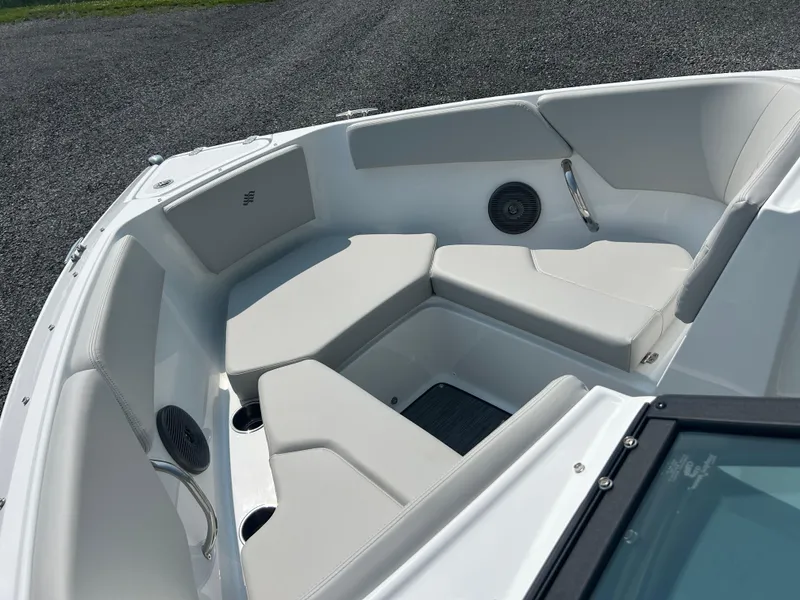 Slide: The Image of 2026 Four Winns H2 Freedom boat interior with cushioned seating and speakers. - 10