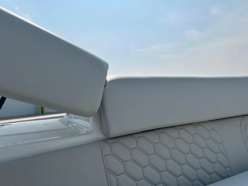 Slide: The Image of 2026 Four Winns H2 Freedom boat interior with white hexagonal-patterned upholstery. - 17