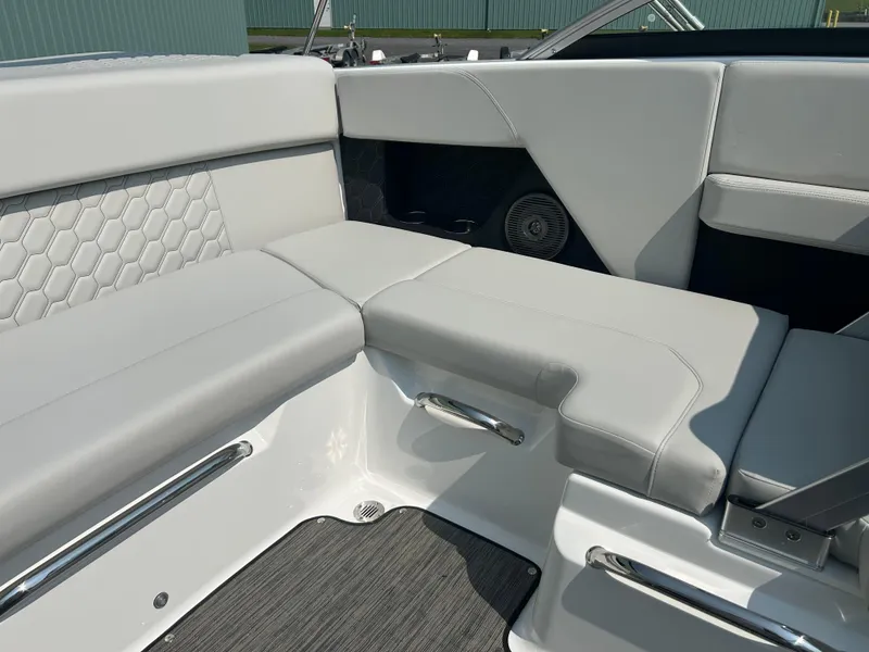 Slide: The Image of 2026 Four Winns H2 Freedom boat interior with gray cushioned seating and modern design. - 19