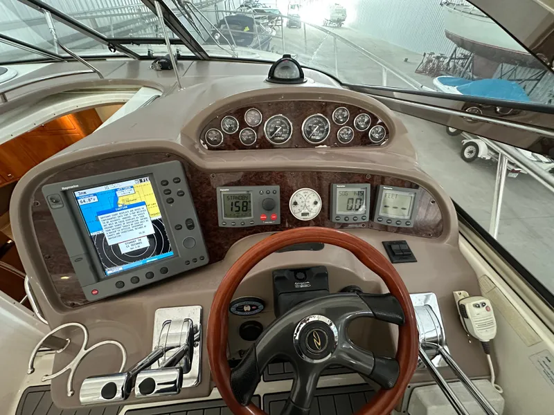 Slide: The Image of Helm of 2004 Regal Commodore 3860 with navigation instruments and steering wheel. - 10