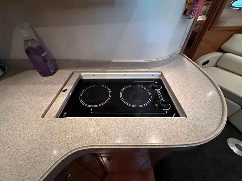 Slide: The Image of 2004 Regal Commodore 3860 yacht kitchen with electric stovetop and countertop. - 16