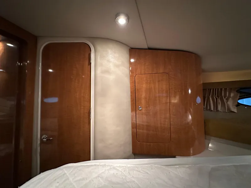 Slide: The Image of 2004 Regal Commodore 3860 cabin interior with wooden cabinetry and soft lighting. - 19