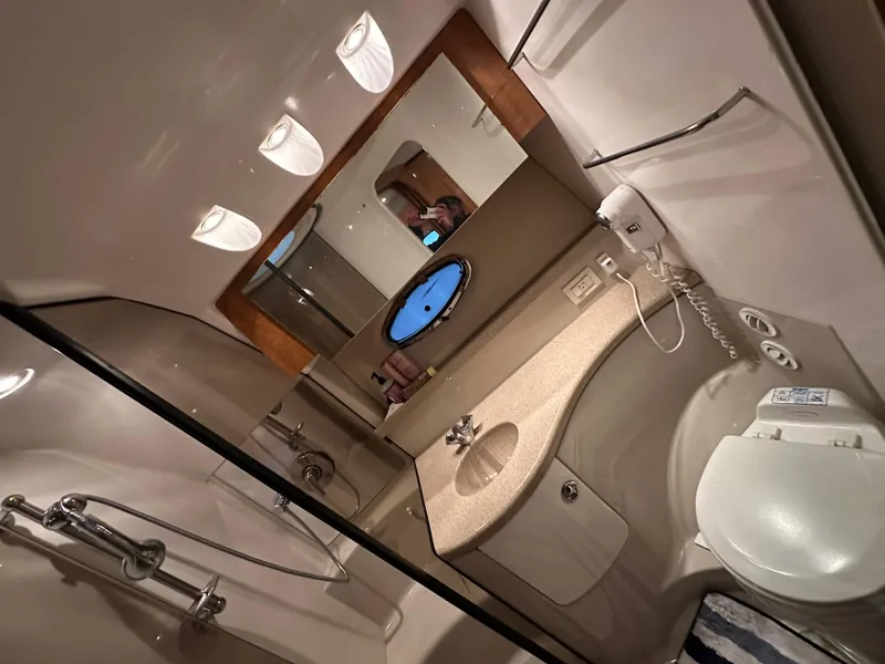 Slide: The Image of Bathroom interior of 2004 Regal Commodore 3860 yacht with shower, sink, and toilet. - 20