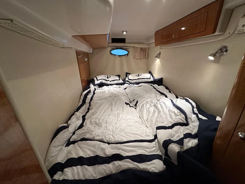 Slide: The Image of Luxurious cabin interior of 2004 Regal Commodore 3860 yacht with cozy bedding. - 23