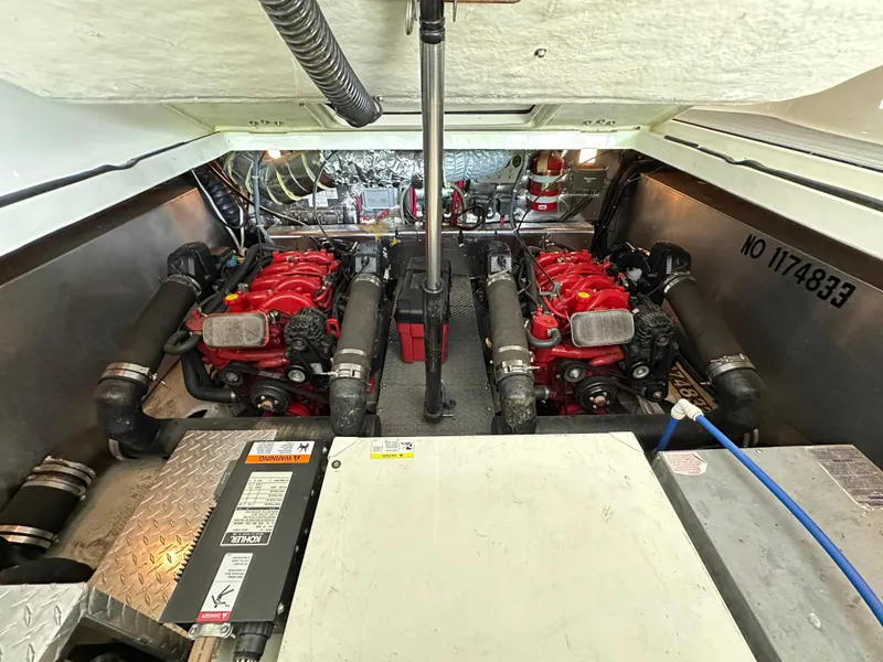 Slide: The Image of Engine room of 2004 Regal Commodore 3860 with dual red engines and mechanical components. - 25