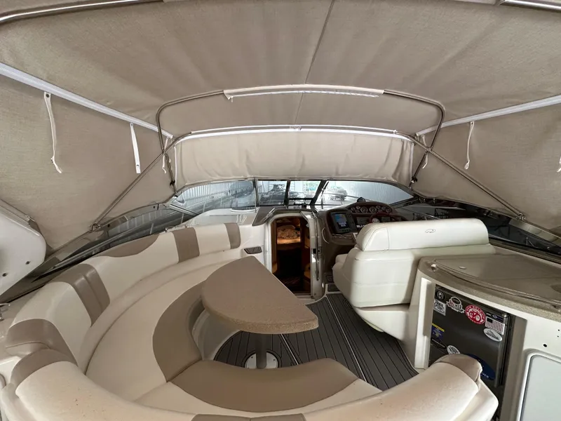 Slide: The Image of 2004 Regal Commodore 3860 yacht interior with beige seating and helm station. - 4