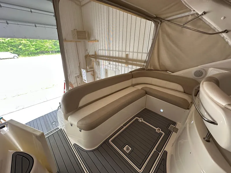 Slide: The Image of 2004 Regal Commodore 3860 boat interior with beige seating and gray flooring. - 5