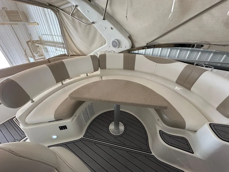 Slide: The Image of 2004 Regal Commodore 3860 interior with curved seating and table, featuring modern design elements. - 7