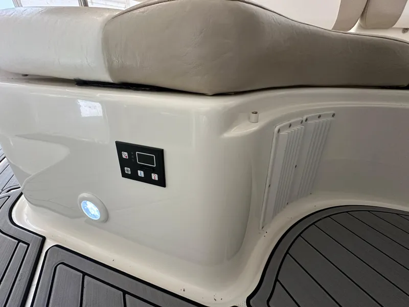 Slide: The Image of 2004 Regal Commodore 3860 boat interior with cushioned seating and control panel. - 8