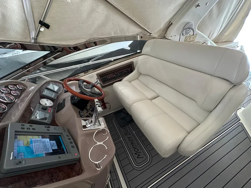 Slide: The Image of 2004 Regal Commodore 3860 boat cockpit with leather seating and modern navigation controls. - 9