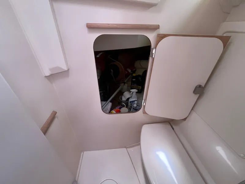 Slide: The Image of Interior of 2014 Hanse 345 yacht showing storage compartment and seating area. - 28
