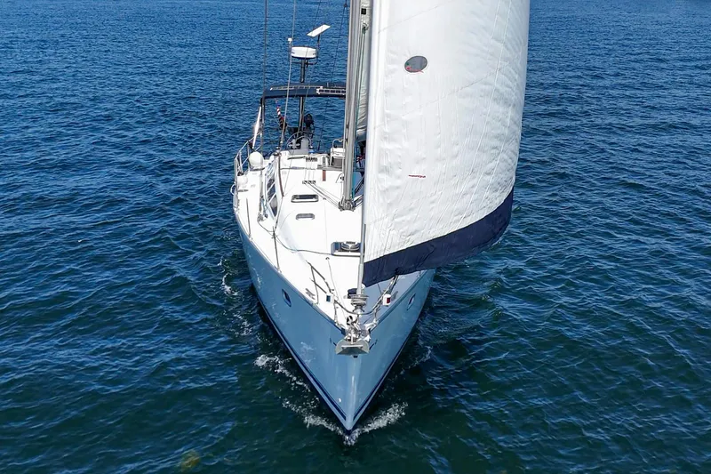 Slide: The Image of Jeanneau Sun Odyssey 43 sailboat from 2002 navigating on open water. - 14