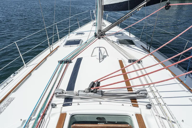 Slide: The Image of Deck view of 2002 Jeanneau Sun Odyssey 43 sailboat with rigging and ocean backdrop. - 19