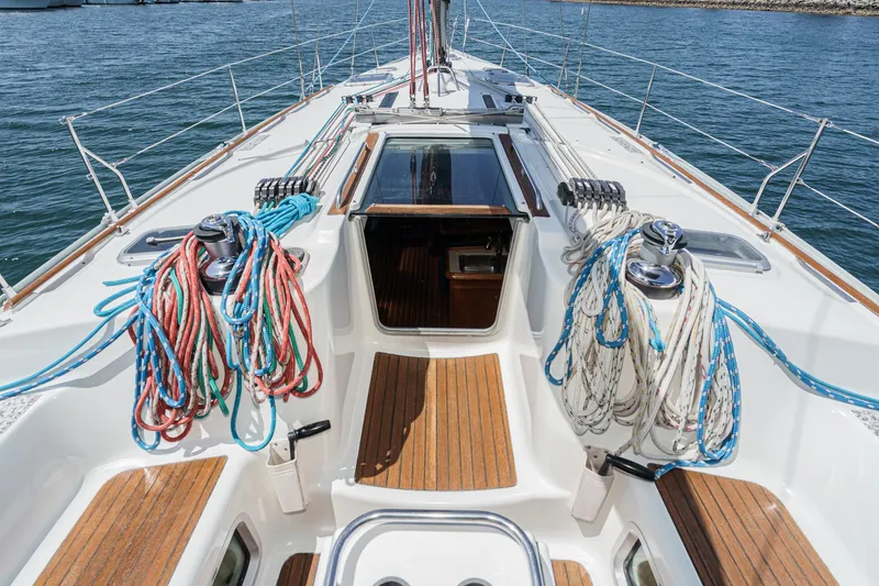 Slide: The Image of Deck view of 2002 Jeanneau Sun Odyssey 43 sailboat with colorful ropes and wooden accents. - 20