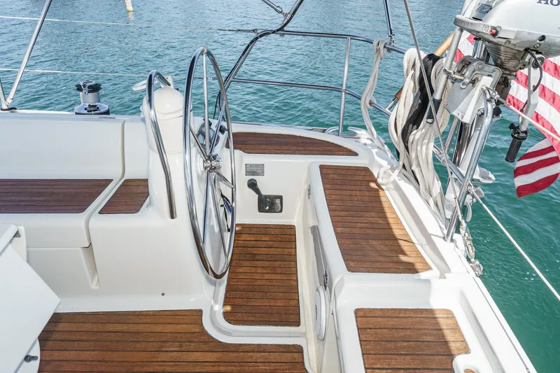 Slide: The Image of Cockpit of 2002 Jeanneau Sun Odyssey 43 sailboat with wooden deck and steering wheel. - 27