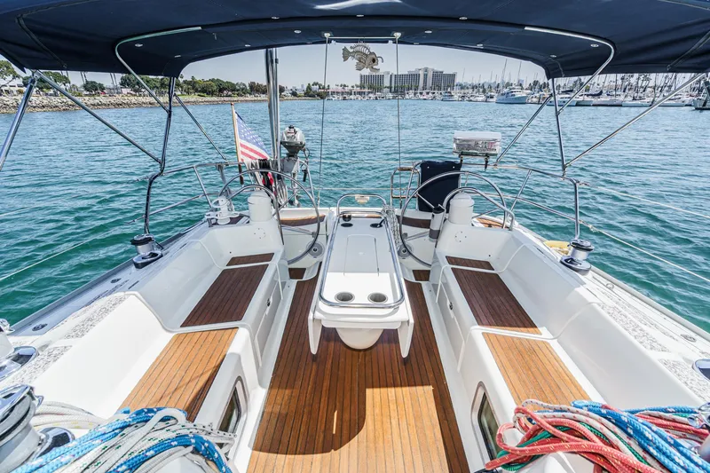 Slide: The Image of Jeanneau Sun Odyssey 43 sailboat cockpit, 2002 model, with teak flooring and marina view. - 29