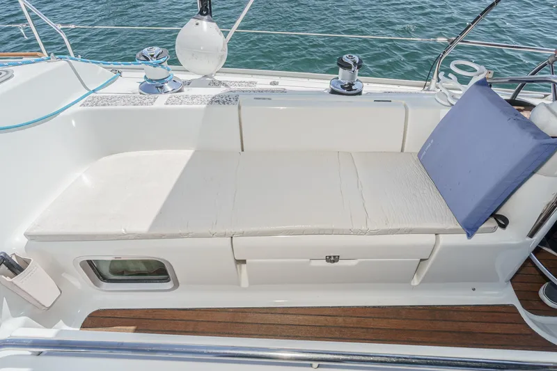 Slide: The Image of Jeanneau Sun Odyssey 43 sailboat deck with cushioned seating, 2002 model. - 36
