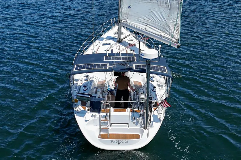 Slide: The Image of Jeanneau Sun Odyssey 43 sailboat, 2002 model, sailing on open water with solar panels. - 38