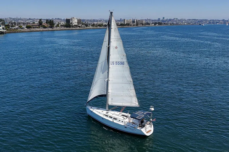 Slide: The Image of Sailboat Jeanneau Sun Odyssey 43, 2002 model, cruising on calm blue waters. - 4