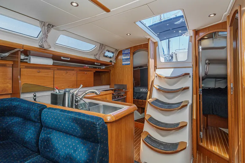 Slide: The Image of Interior of 2002 Jeanneau Sun Odyssey 43 sailboat with kitchen and seating area. - 43