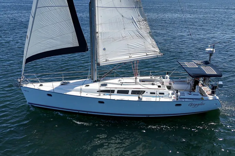 Slide: The Image of 2002 Jeanneau Sun Odyssey 43 sailboat cruising on open water. - 6