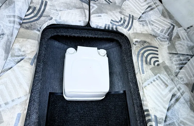 Slide: The Image of 2000 Wellcraft 20 Excalibur boat interior with patterned seating and storage compartment. - 15