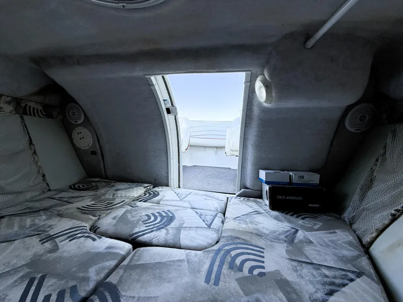 Slide: The Image of Interior cabin of 2000 Wellcraft 20 Excalibur boat with patterned cushions and open hatch. - 16