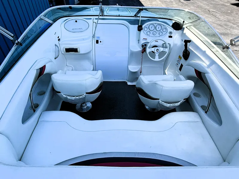 Slide: The Image of 2000 Wellcraft 20 Excalibur boat interior with white seating and dashboard controls. - 19