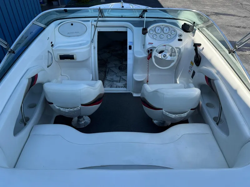 Slide: The Image of 2000 Wellcraft 20 Excalibur boat interior with white seating and dashboard controls. - 6