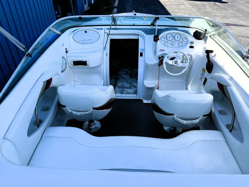 Slide: The Image of 2000 Wellcraft 20 Excalibur boat interior with white seating and dashboard controls. - 8