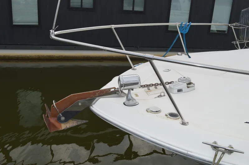 Slide: The Image of 1998 Sea Ray 310 Sundancer bow with anchor and railing in marina. - 16