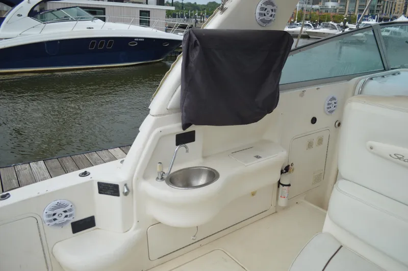 Slide: The Image of 1998 Sea Ray 310 Sundancer boat interior with sink and seating area. - 25