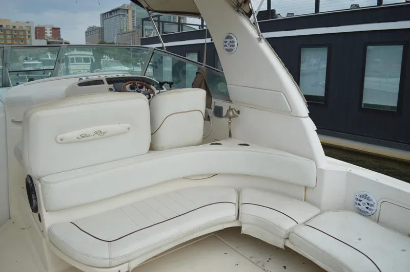 Slide: The Image of 1998 Sea Ray 310 Sundancer boat interior with white seating and dashboard. - 26