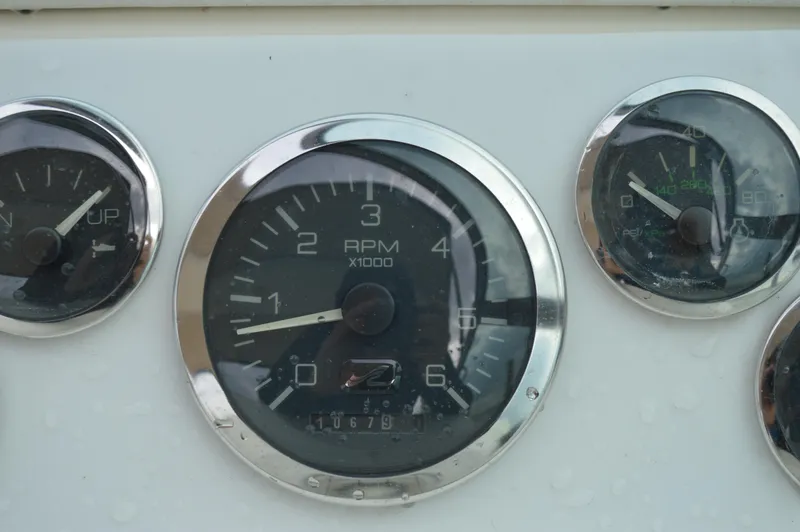 Slide: The Image of Close-up of 1998 Sea Ray 310 Sundancer boat gauges, showing RPM and other indicators. - 29