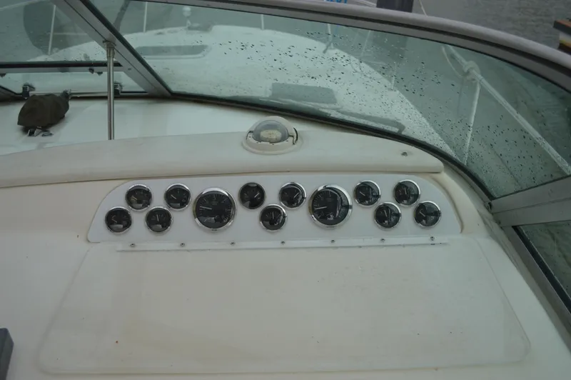 Slide: The Image of Dashboard of a 1998 Sea Ray 310 Sundancer boat with multiple gauges. - 30