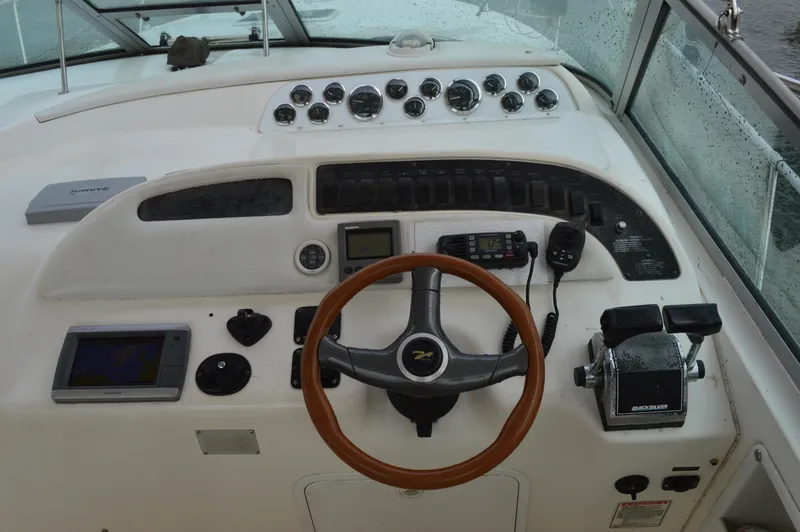 Slide: The Image of Cockpit of 1998 Sea Ray 310 Sundancer with steering wheel and control panel. - 32