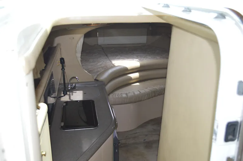 Slide: The Image of Interior of 1998 Sea Ray 310 Sundancer, featuring kitchenette and seating area. - 42