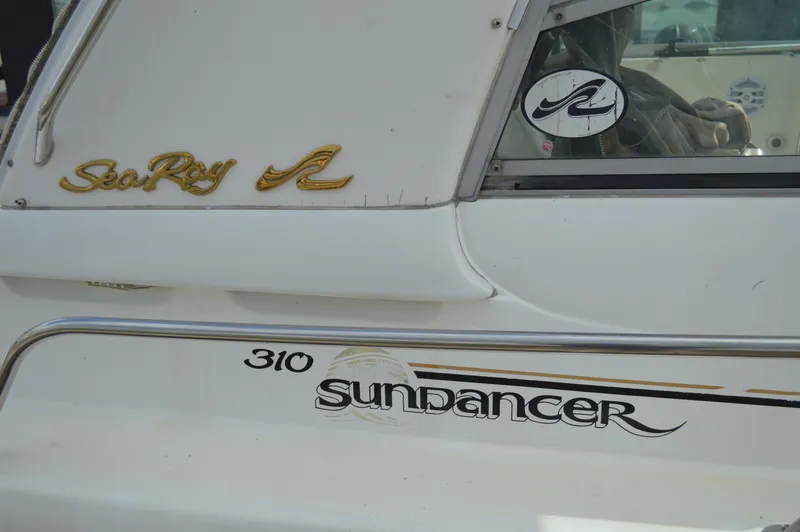 Slide: The Image of 1998 Sea Ray 310 Sundancer boat with logo and model name visible. - 6