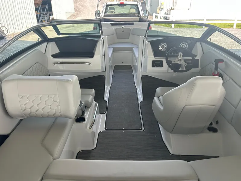 Slide: The Image of 2025 Four Winns H1 boat interior with modern seating and steering wheel. - 7