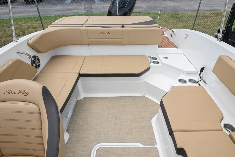 Slide: The Image of 2018 Sea Ray SPX 210 Outboard boat interior with tan seating and cup holders. - 13