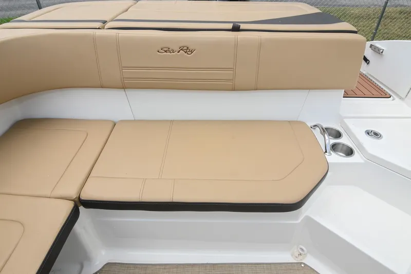 Slide: The Image of 2018 Sea Ray SPX 210 Outboard boat interior with tan seating and cup holders. - 15