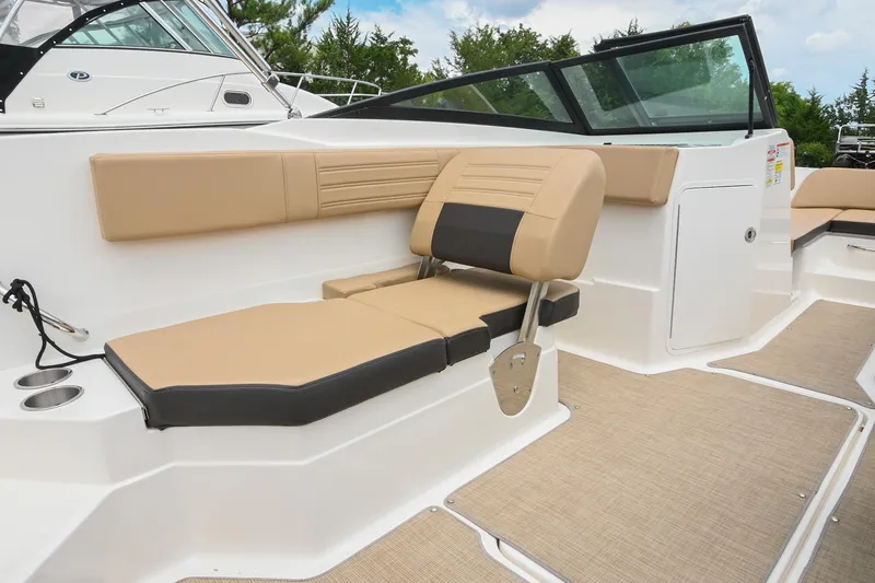 Slide: The Image of 2018 Sea Ray SPX 210 Outboard boat interior with beige seating and cup holders. - 17