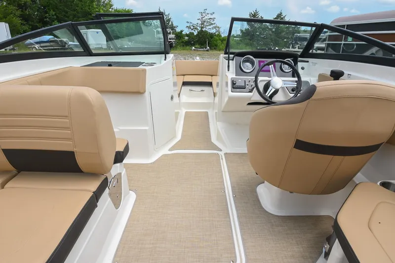 Slide: The Image of 2018 Sea Ray SPX 210 Outboard interior with tan seating and modern dashboard. - 19