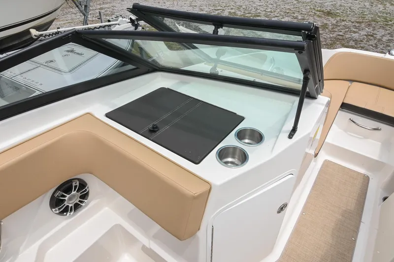 Slide: The Image of 2018 Sea Ray SPX 210 Outboard boat interior with beige seating and cup holders. - 22