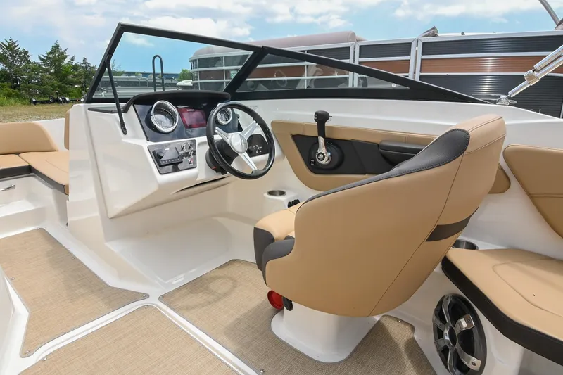 Slide: The Image of 2018 Sea Ray SPX 210 Outboard boat interior with beige seating and modern dashboard. - 23